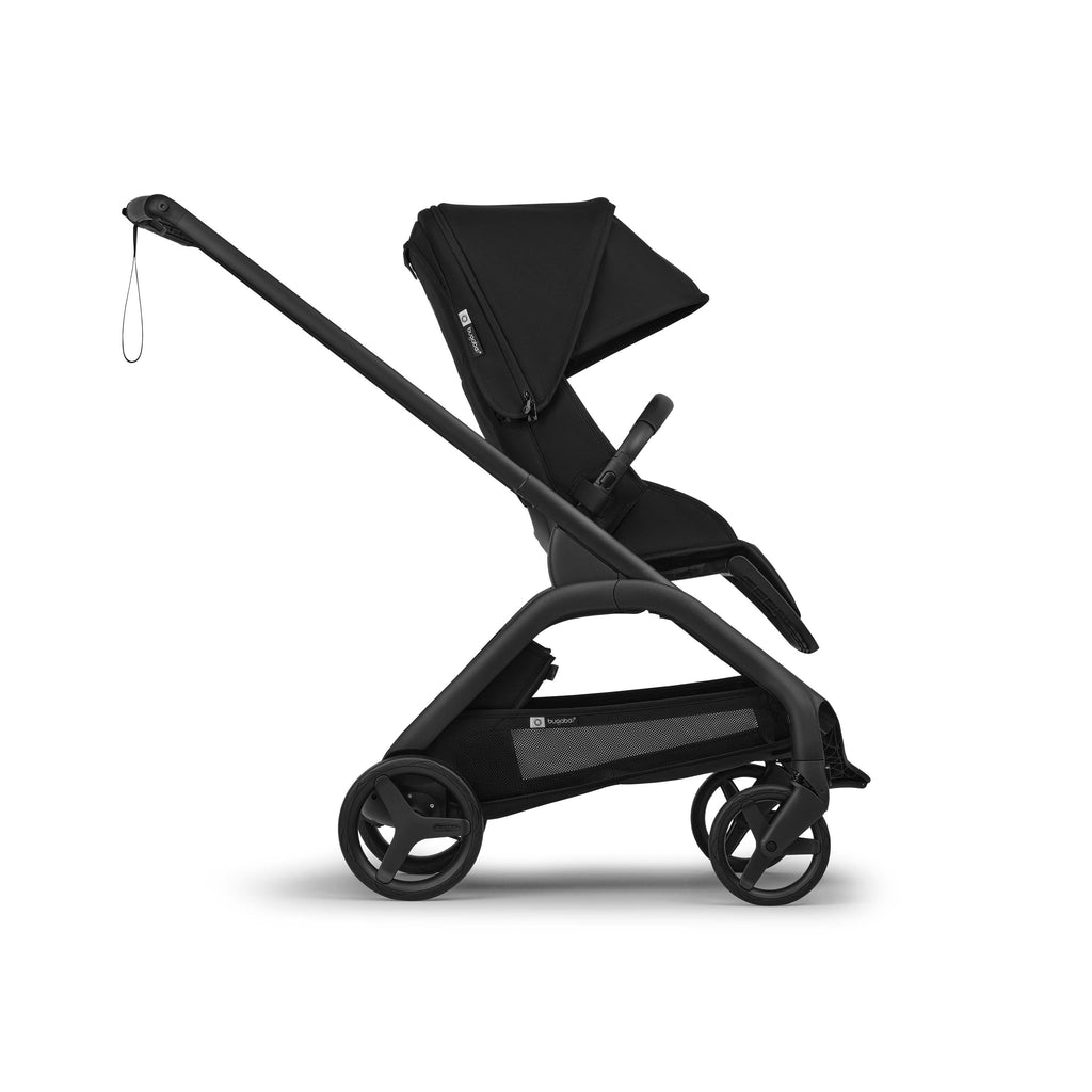 Side shot of a black Bugaboo Dragonfly Plus stroller in world facing mode on a white background