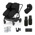 A black double stroller travel system set displayed on a clean white background, including the stroller, bassinet, footmuff, diaper pail, seat cover, handlebar cover, and storage pouch.