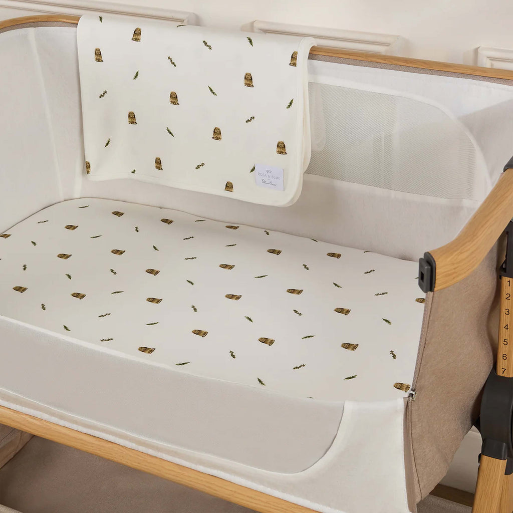 Silver Cross lunar baby crib with white rabbit patterned sheet and blanket