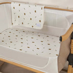 Silver Cross lunar baby crib with white rabbit patterned sheet and blanket