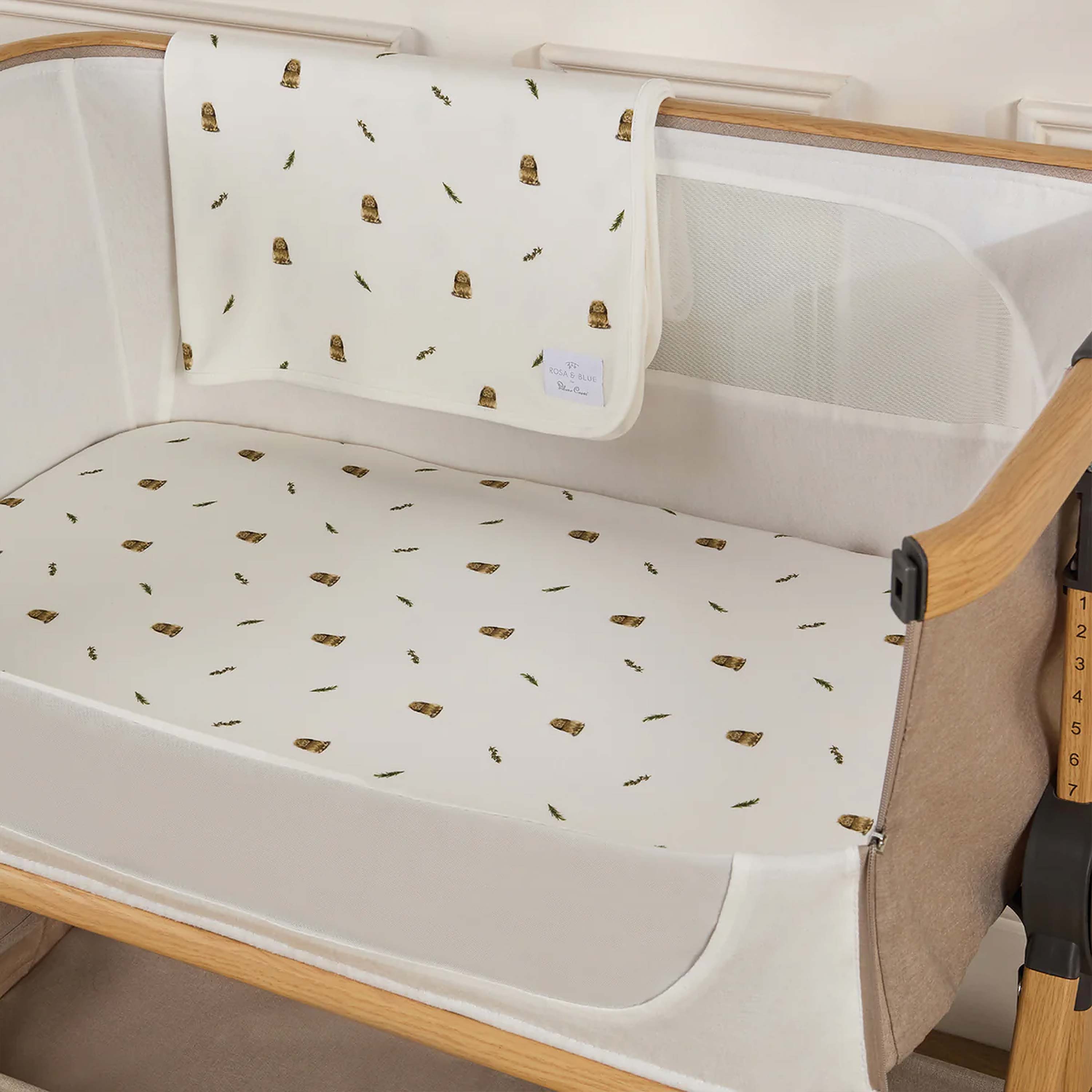 Silver Cross lunar baby crib with white rabbit patterned sheet and blanket
