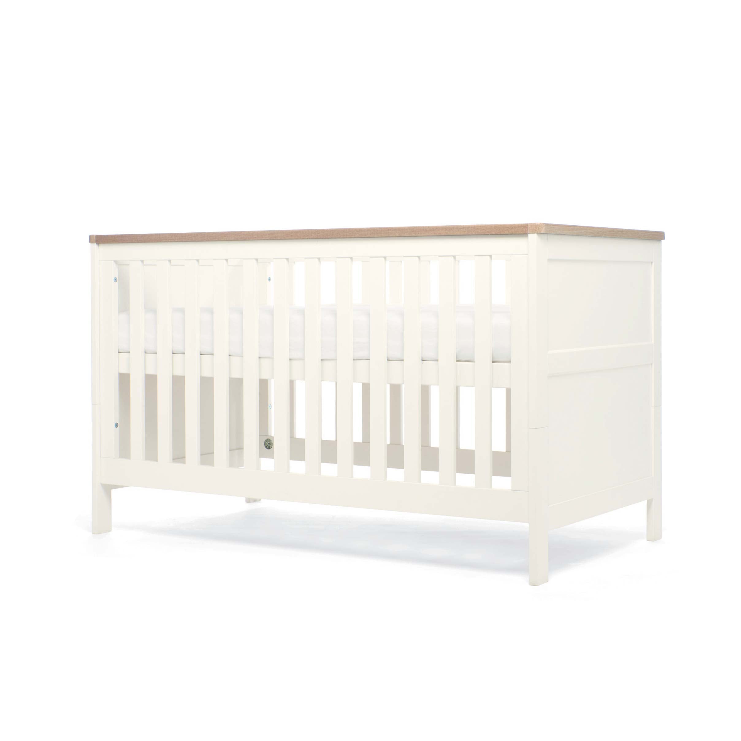 White cot bed with natural top showing highest base position on a white background