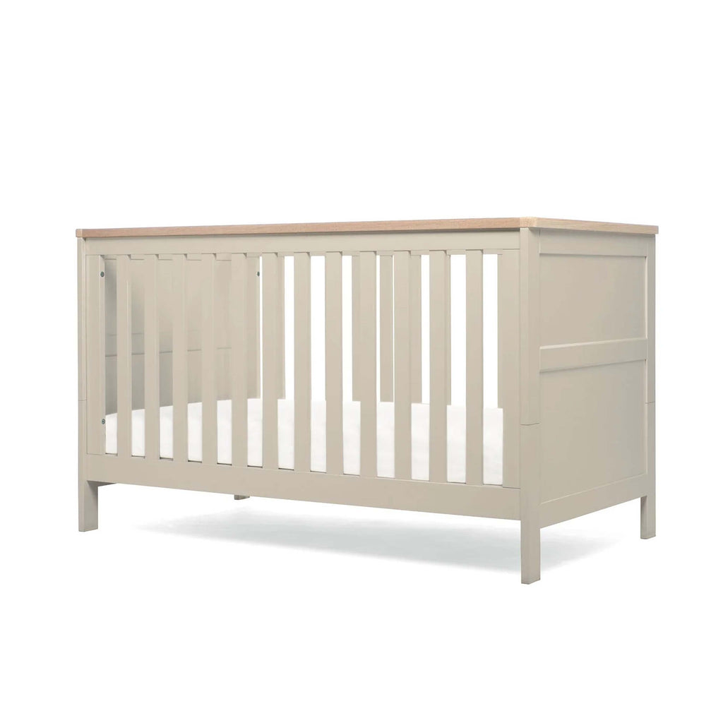 Pebble Grey Cot Bed with wooden top and base in lowest position on white background
