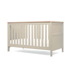 Pebble Grey Cot Bed with wooden top and base in lowest position on white background