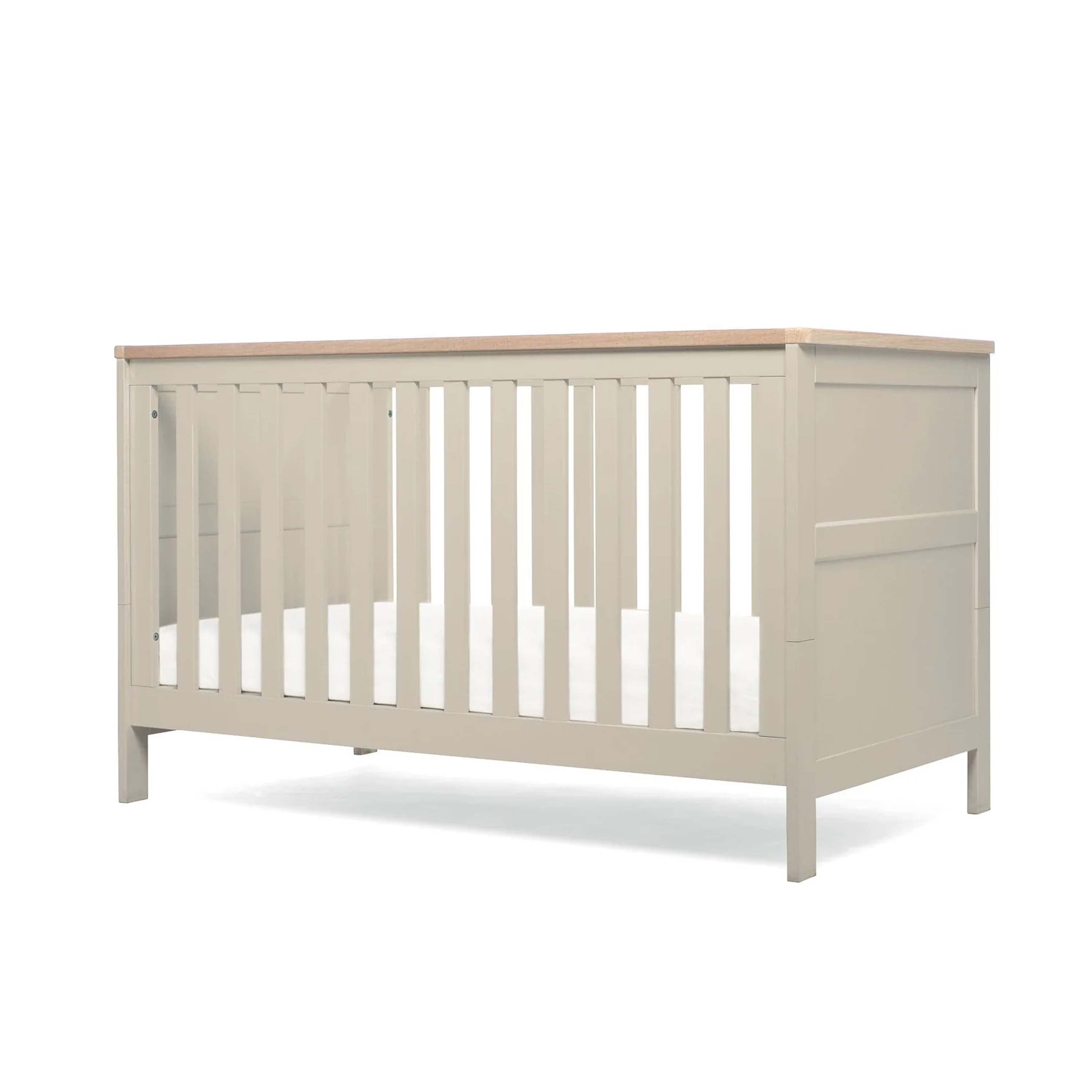 Pebble Grey Cot Bed with wooden top and base in lowest position on white background