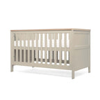 Pebble Grey crib with wooden top and base in highest position on a white background