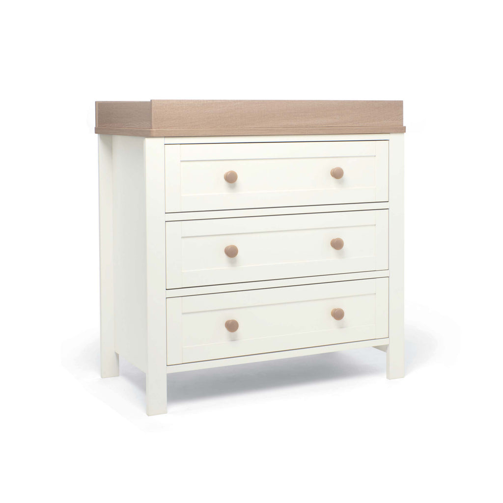 White dresser with three drawers and a natural top changer frame on a white background