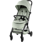 A compact stroller in a light sage green fabric with a grey frame and wheels, shown from a three-quarter angle on a solid white background.
