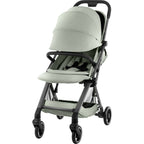 A compact stroller with a light sage green fabric body and a grey frame with extended canopy, shown from a three-quarter angle against a plain white background.