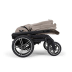 Black chassis with beige folded stroller on a white background