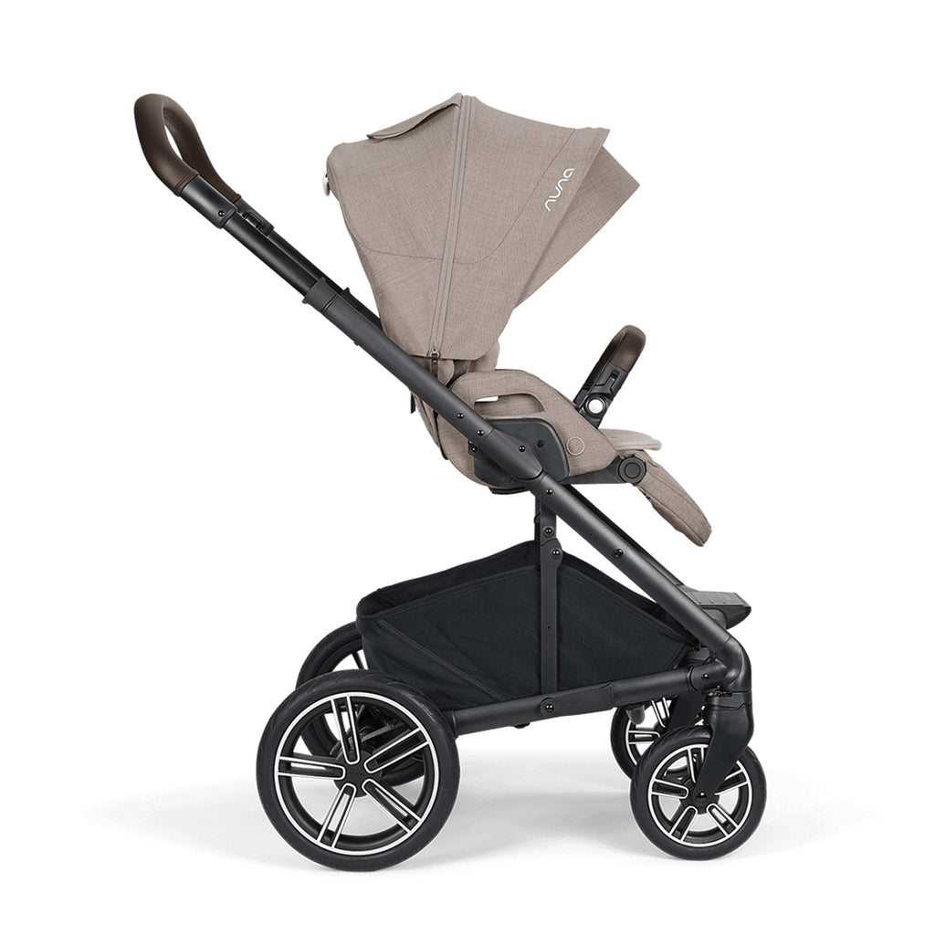 Stroller side view with beige canopy on a white background