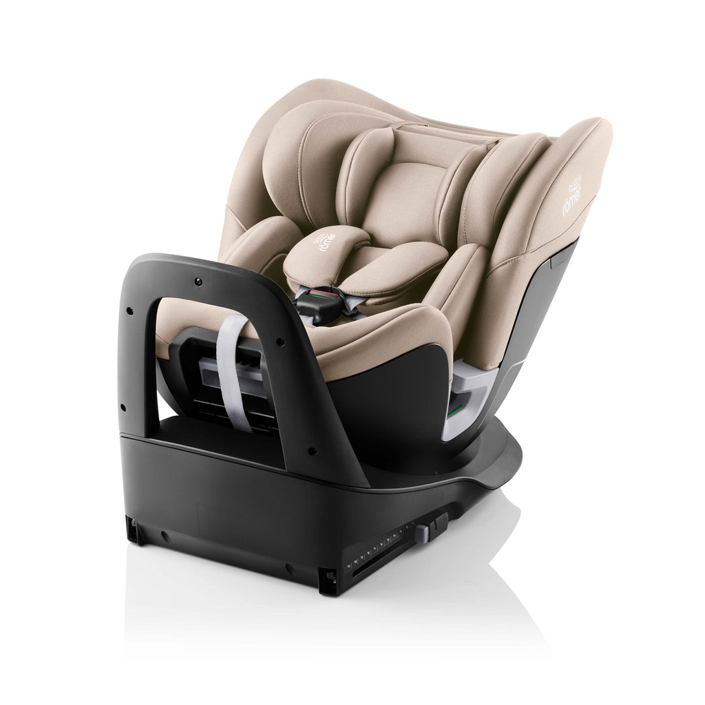 Beige infant car seat on a  black isofix base on a white background