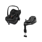A Maxi-Cosi safety car seat in black with a black handle, shown next to its matching black Isofix base on a clean white background.