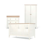 White and natural nursery furniture set with cot bed, dresser, and wardrobe on a white background